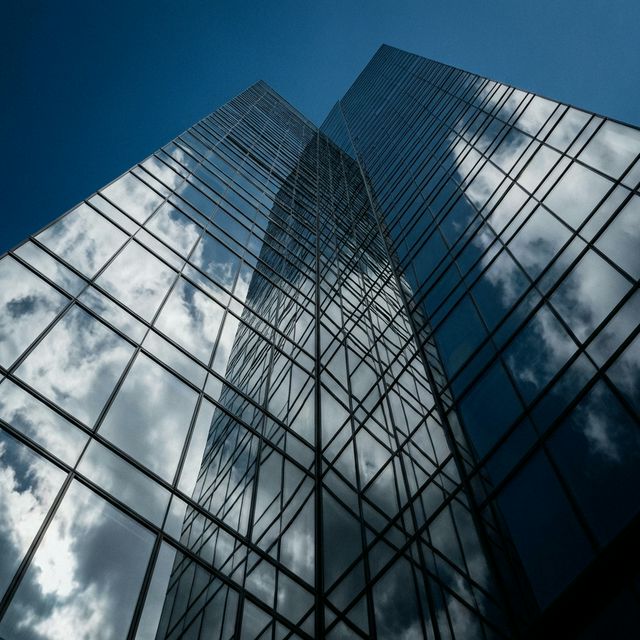 Redwood RE capital structuring — modern glass facade commercial real estate